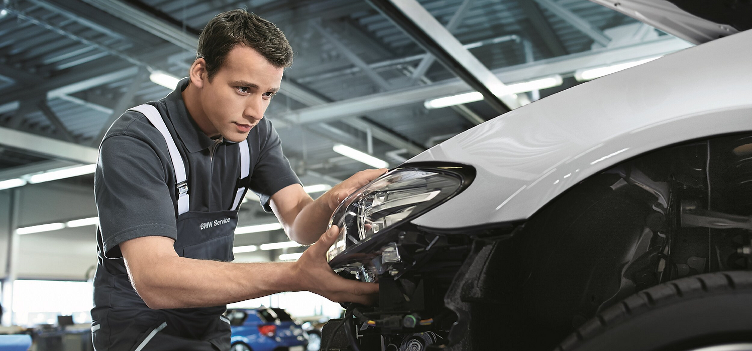 Man repairing a headlight